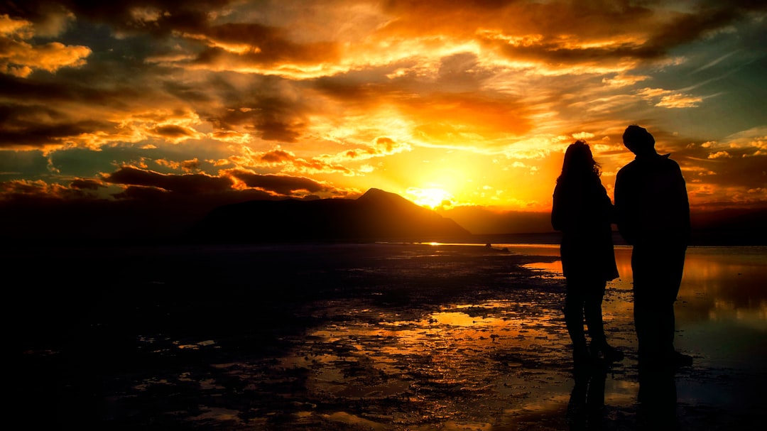 Couple watching sunset over the lake